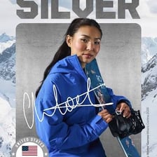 Chloe Kim performing a snowboarding maneuver in a halfpipe