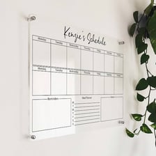 A weekly planner showing appointments repeated on a schedule beside a wall clock.