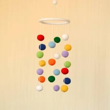 A decorative mobile suspended from a ceiling by a string