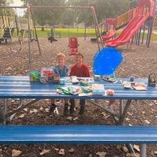 People searching outdoors alongside children gathered for an overnight slumber party.