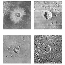 Large circular impact craters visible on a rocky planetary surface.