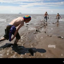 A person trudging through muddy ground