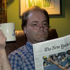 A person reading news on a tablet.