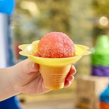 A colorful shaved-ice Sno-Cone in a paper cup