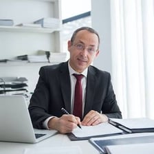 An accountant reviewing financial documents at a desk.