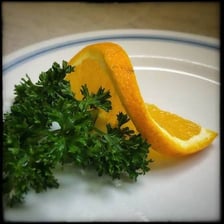A small fresh sprig of parsley used as a garnish