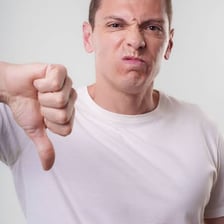 A person expressing disapproval with a finger-wagging gesture.