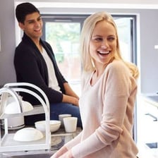 Two people jointly holding an object to represent shared ownership