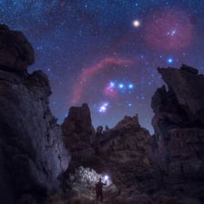 The three aligned stars of Orion’s Belt in the night sky.