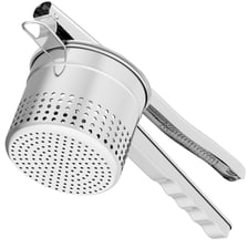 A handheld potato ricer filled with cooked potato.