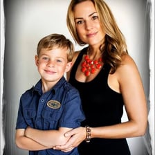 A mother standing with her young son.
