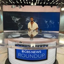 A reporter working on a breaking news story in a newsroom.