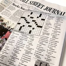 A newspaper crossword with a visible clue list.