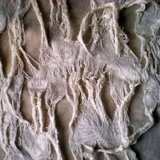 A piece of fabric with visibly tattered edges