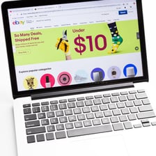 A laptop displaying the eBay online marketplace.