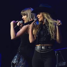 Two singers performing together in a musical duet