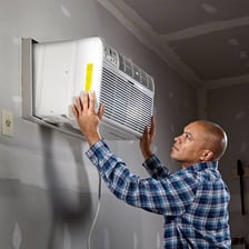 Wall-mounted air conditioners cooling an indoor room.