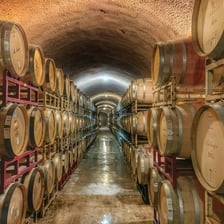 Wine barrels in a cellar, illustrating the process of aging.