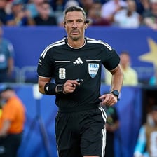 A referee officiating a soccer match