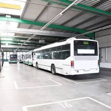 A passenger bus parked at a transportation depot.