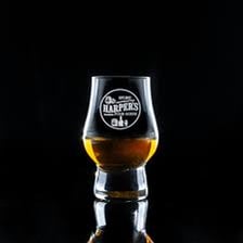A small serving of whiskey in a glass.