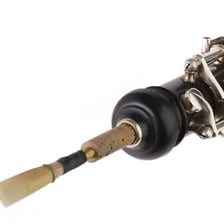 A black oboe with its keys and reed visible.