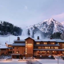 A lodge beside snow-covered ski slopes