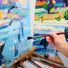 An artist carefully and skillfully painting a work of art.