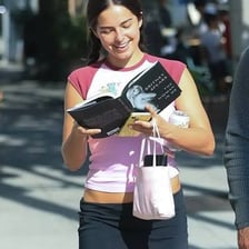 A person casually reading a celebrity magazine.