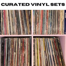 A collection of long-playing vinyl records in their sleeves.