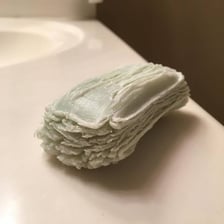 A bar of soap resting in a shower.