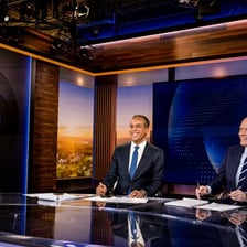A television news anchor presenting an evening newscast