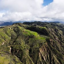A scenic view of Ojai, California, with its surrounding valley and mountains.