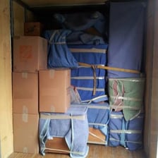 A moving van loaded with household boxes