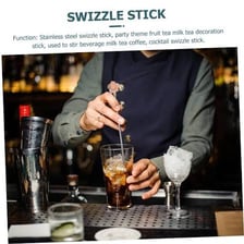 A bartender stirring a cocktail with a swizzle stick.