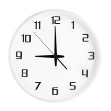 A clock showing 9 p.m. beside a television.