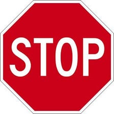 A red stop sign beside a road