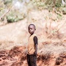 A young boy standing outdoors.