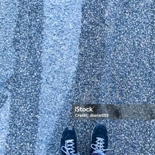 A person's feet wearing shoes.