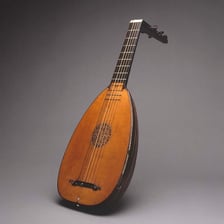 A wooden lute with its rounded body and neck