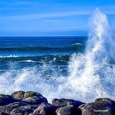 Large ocean wave moving toward a shoreline