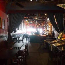 A dimly lit, informal neighborhood bar