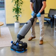 Vacuum cleaners being used to clean a floor