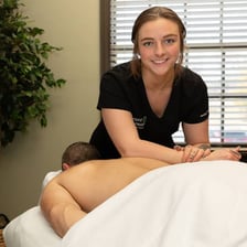 A massage therapist providing treatment in a spa