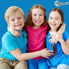 Children playing a simple card game with a deck spread on a table.