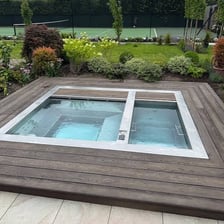 An outdoor hot tub filled with steaming water