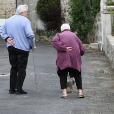 An older adult walking outdoors