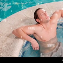 A person relaxing in a steaming hot tub.