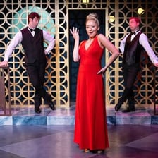 Performers presenting an act on a theater stage