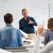 A college professor teaching students in a classroom.